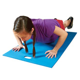 A girl doing push-ups on a blue mat, showcasing her workout routine and commitment to fitness.